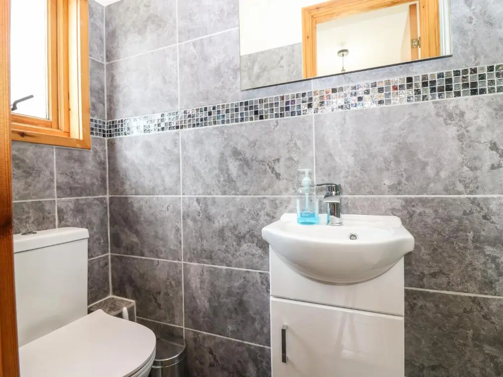 a bathroom with a sink and a toilet at Birchbank in Skye of Curr