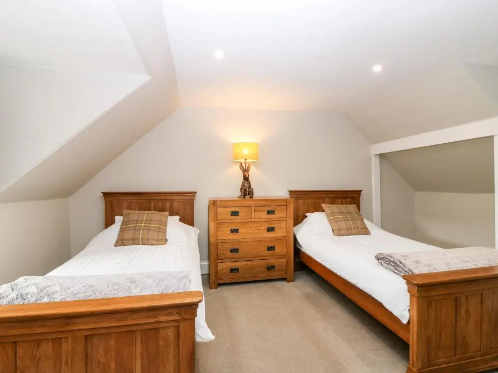 two twin beds in a attic bedroom at White Hillocks Farm House in Inchmill