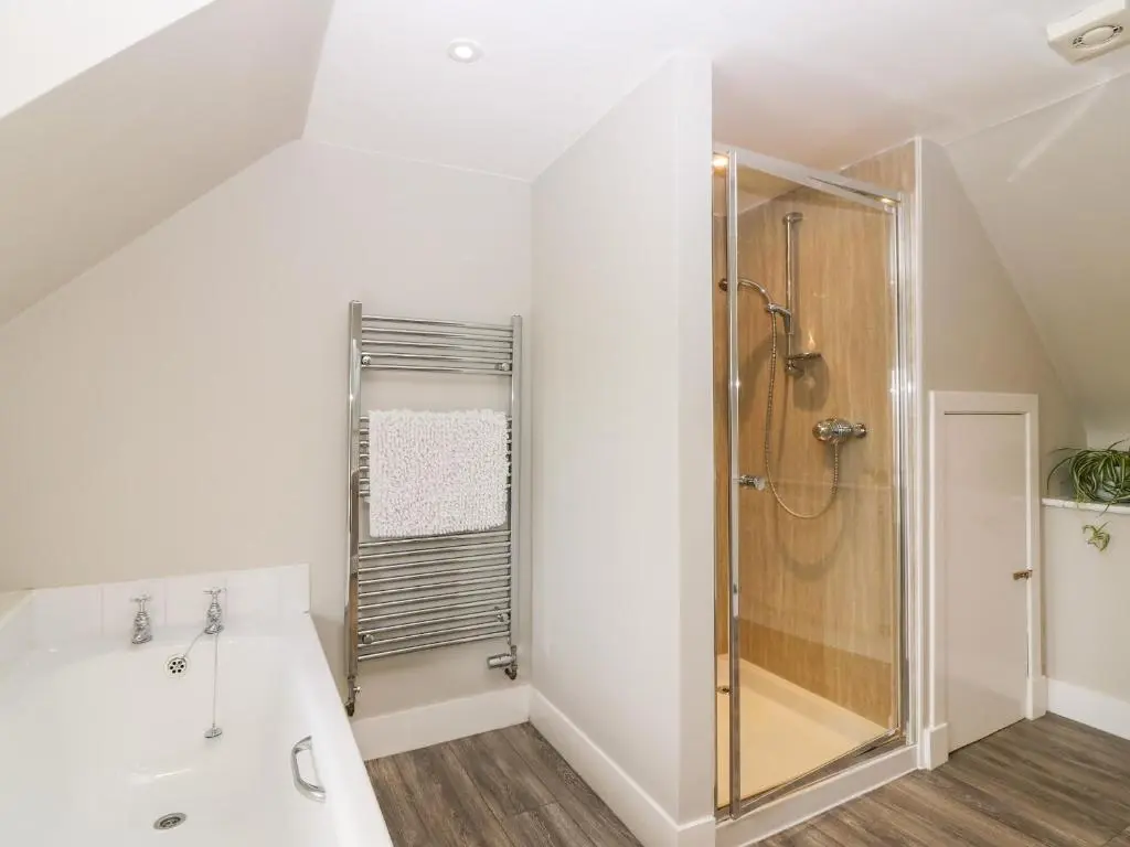 a white bathroom with a shower and a sink at White Hillocks Farm House in Inchmill