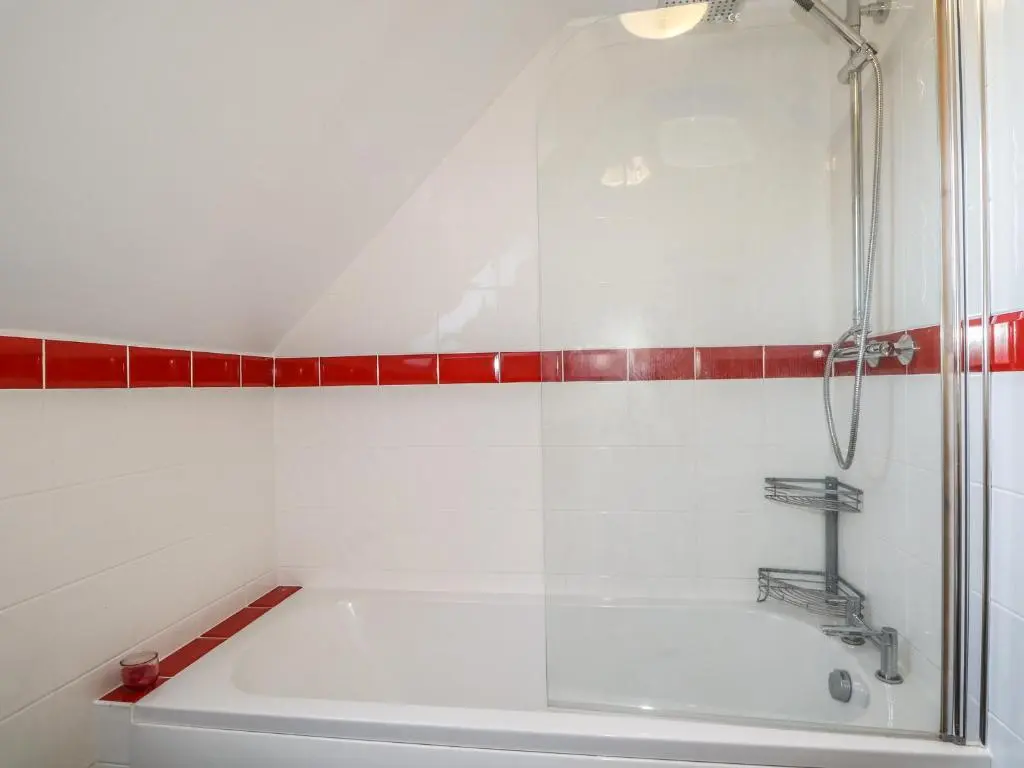 a bathroom with a shower and a white tub at Corriemhor Beag in Cromdale