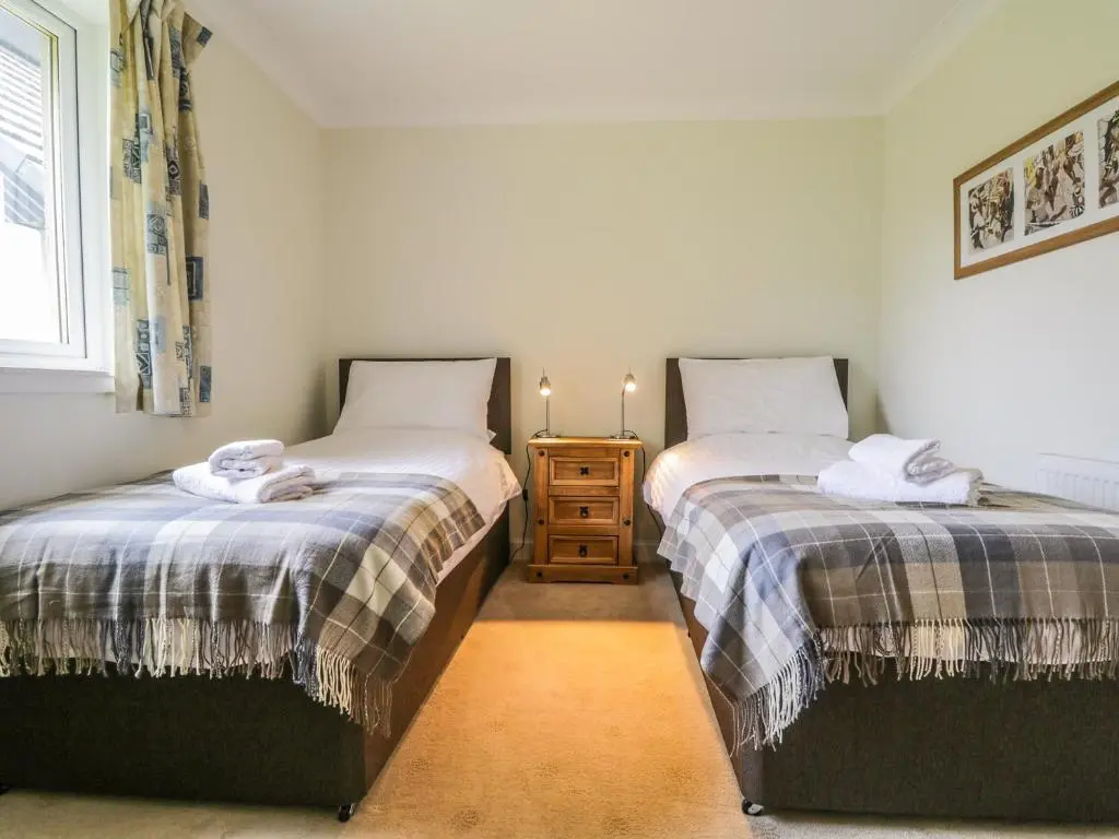 two beds sitting next to each other in a room at Glaven in Bonar Bridge