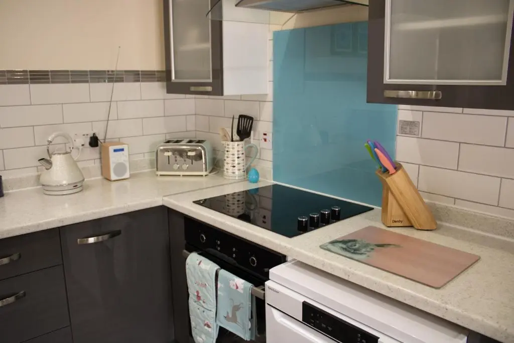a kitchen with a stove and a counter top at Buttermere Cottage in Banff
