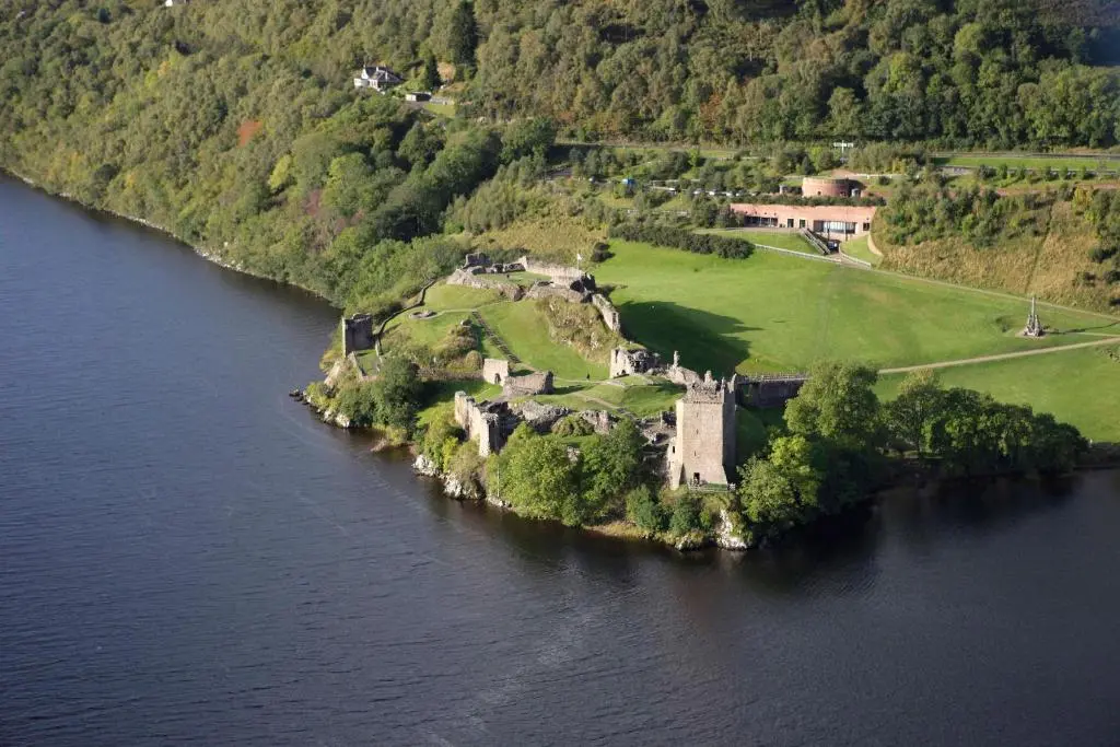 an island in the water with a house on it at Inverness City Suites in Inverness