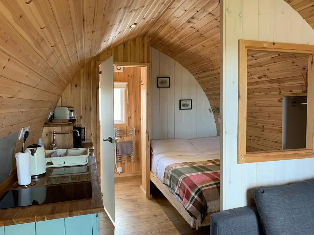 a bedroom with a bed and a sink in a room at Hillside Havens in Dufftown