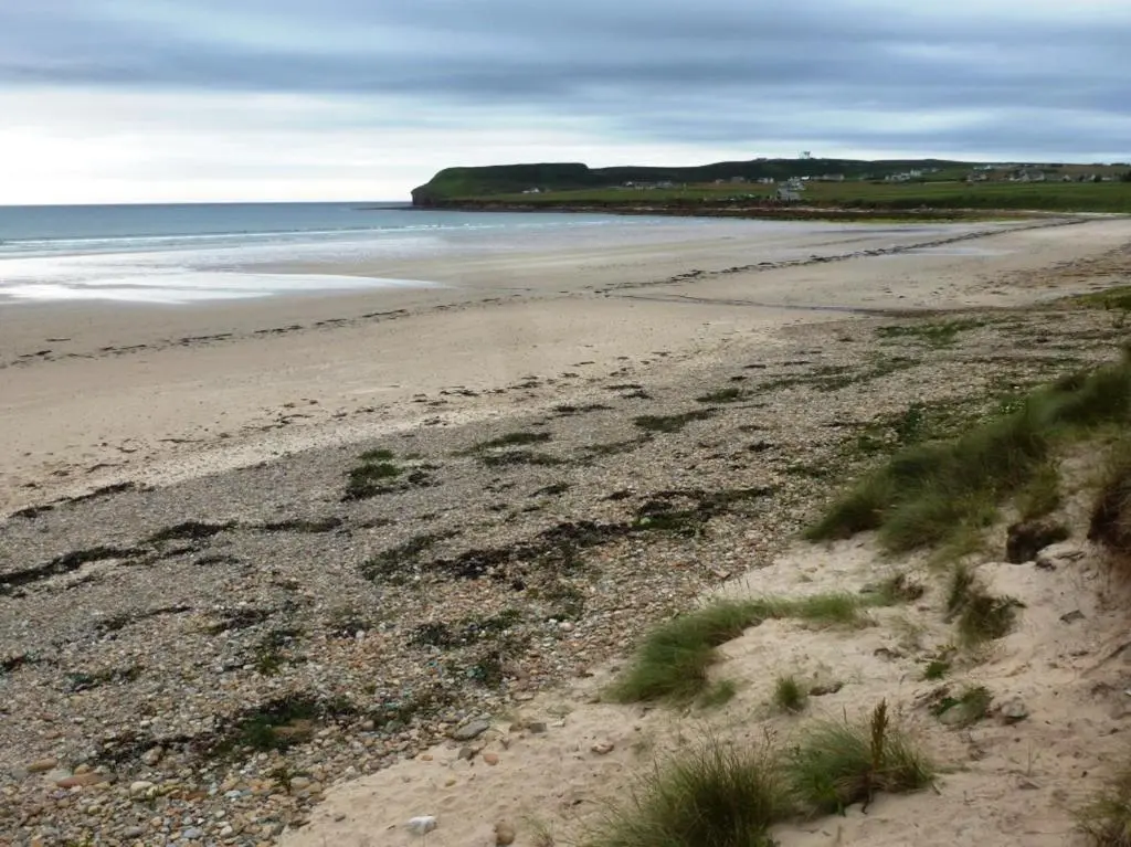 a sandy beach with a view of the ocean at Norseman Hotel in Wick
