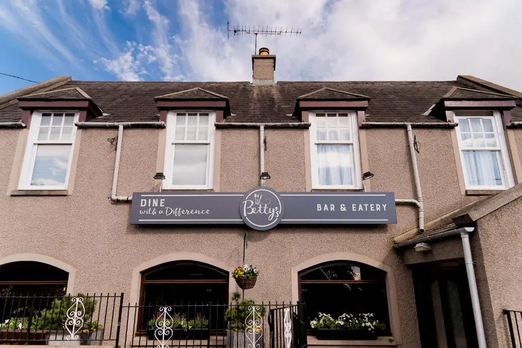 a building with a sign for a bar and tavern at Leys Hotel in Aberdeen