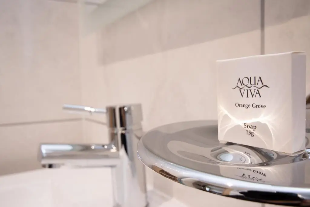 a white container sitting on top of a sink in a bathroom at Loch Earn in Inverness