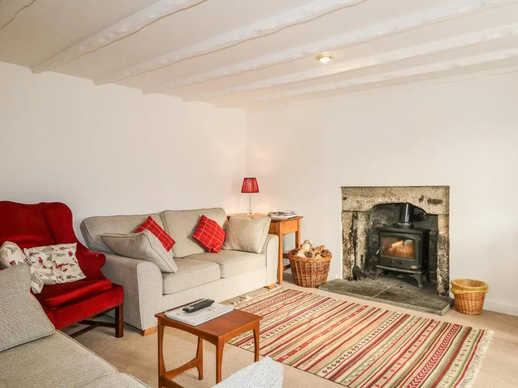 a living room with a couch and a fireplace at Newlands in Archiestown