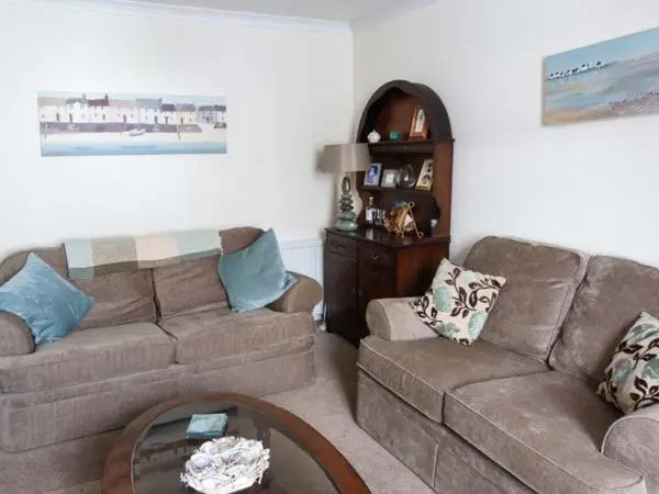 a living room with a couch and a coffee table at Seascape in Buckie