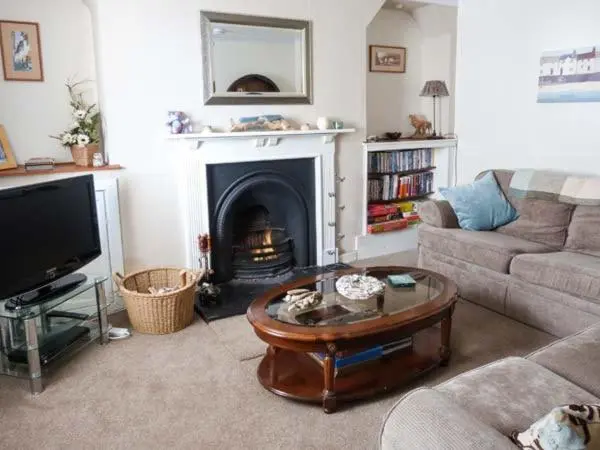 a living room with a couch and a coffee table at Seascape in Buckie
