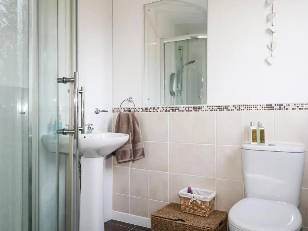 a bathroom with a toilet and a sink and a shower at Seascape in Lossiemouth