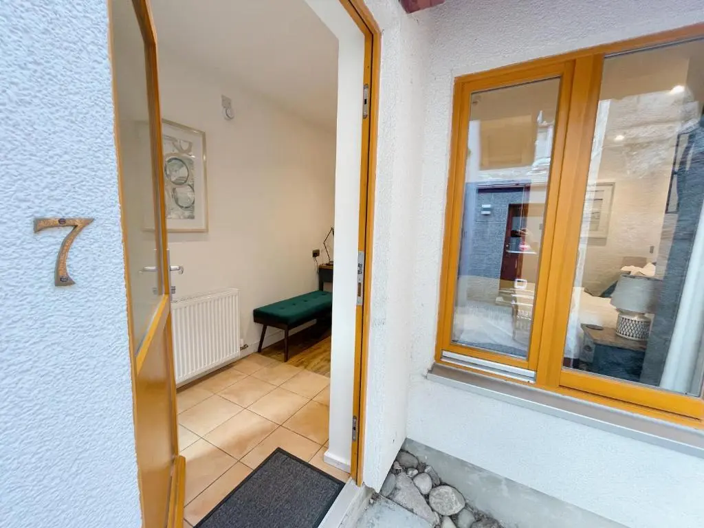 a door leading into a room with a window at Ravenscraig Guest House in Aviemore