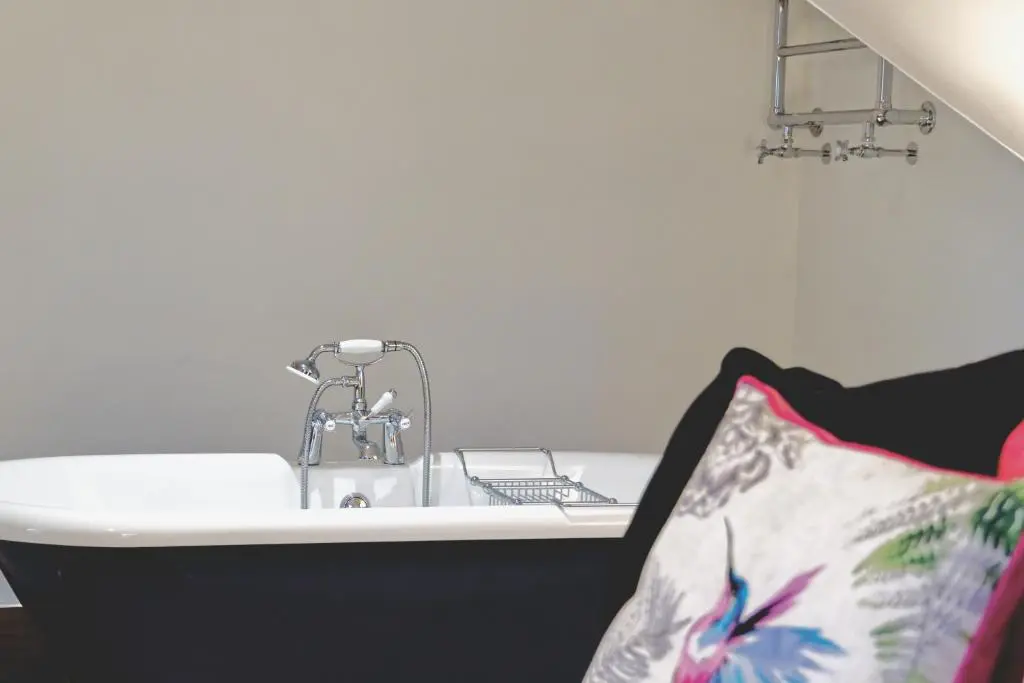 a bath tub with a sink in a room at Mount Barker in Grantown on Spey