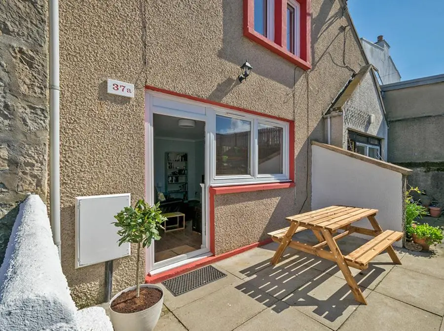 a picnic table in front of a building at 37A Commerce Street in Lossiemouth