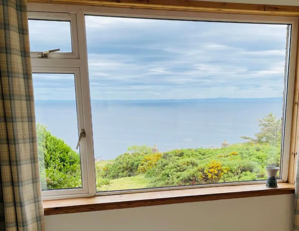 a window with a view of the ocean at The Stroops in Helmsdale