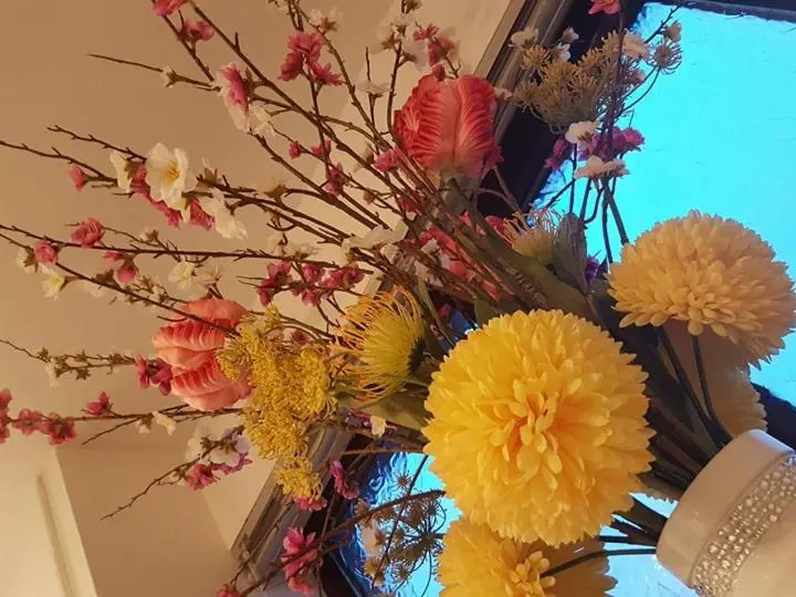 a bunch of flowers in a vase on a ceiling at Yvi's 2-3 Bedroom Town Apartment in Inverurie