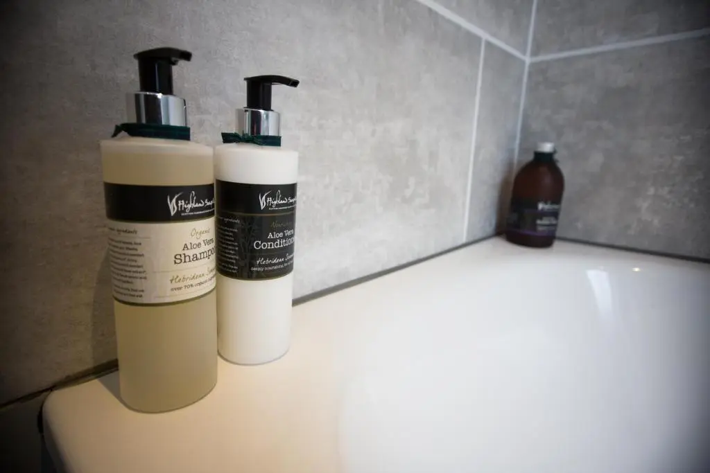 two bottles ofodorizers sitting on top of a sink at Cairn Leuchan in Ballater