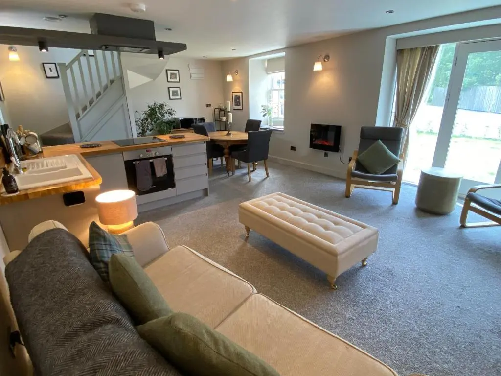 a living room with a couch and a table at Cairn Leuchan in Ballater