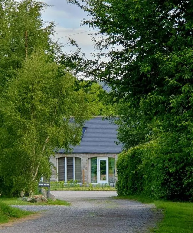 a house with a gravel road in front of it at Cairn Leuchan in Ballater