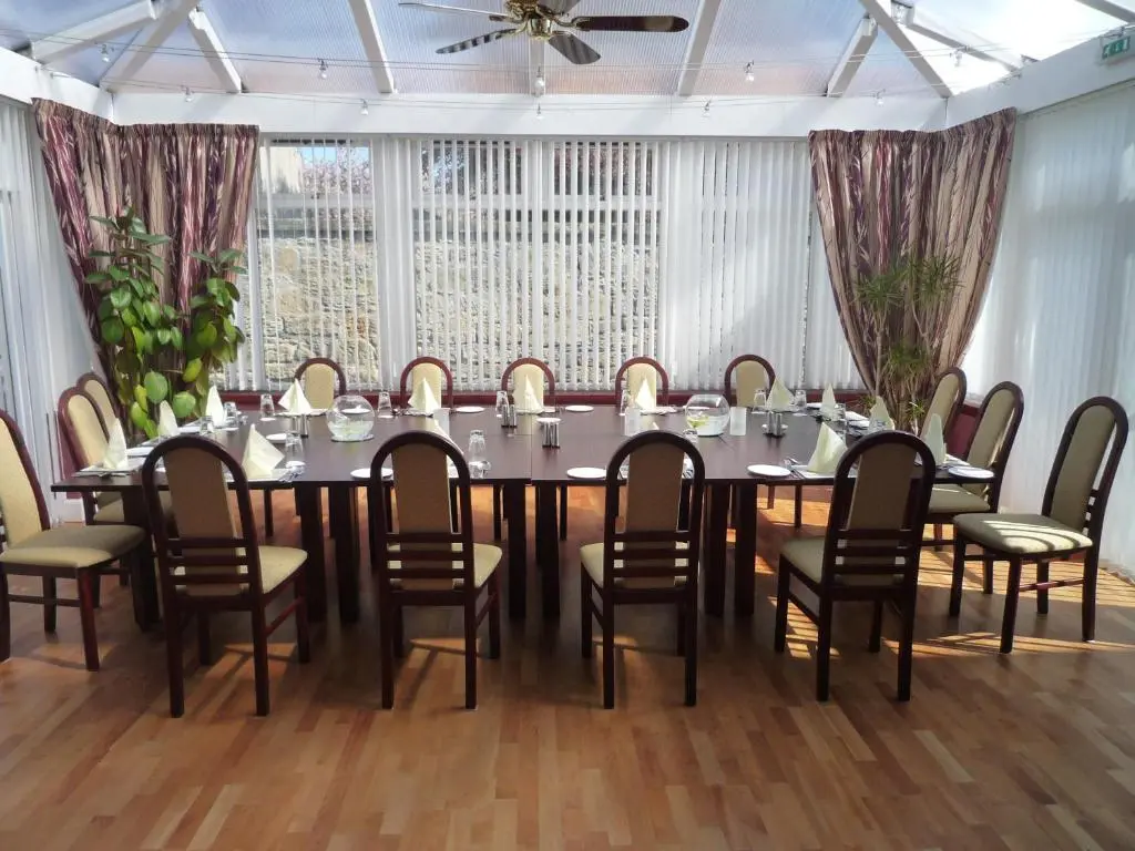 a conference room with a large table and chairs at Sunninghill Hotel in Elgin