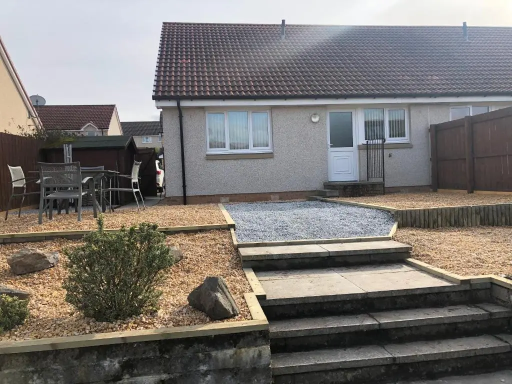 a house with a yard with stairs and a patio at Holm from Home in Inverness