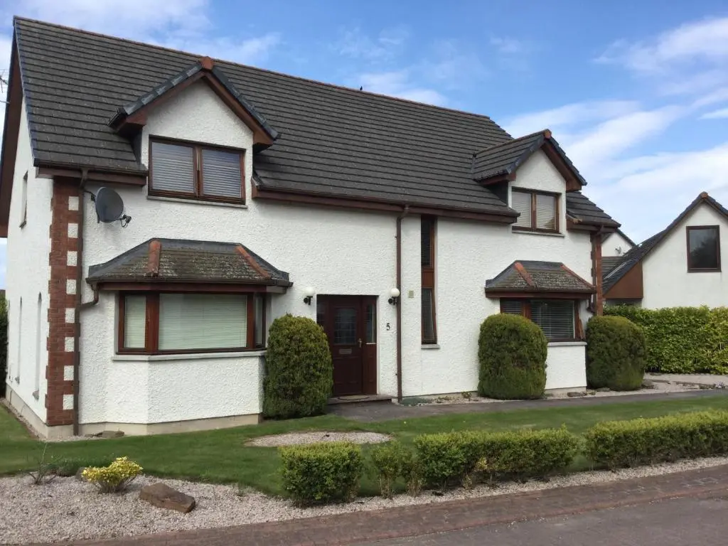 a white house with a black roof at West Heather House Free Parking in Inverness
