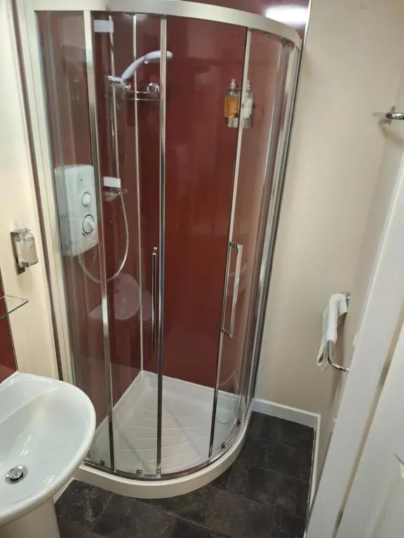 a bathroom with a shower and a sink at Torridon Guest House in Inverness