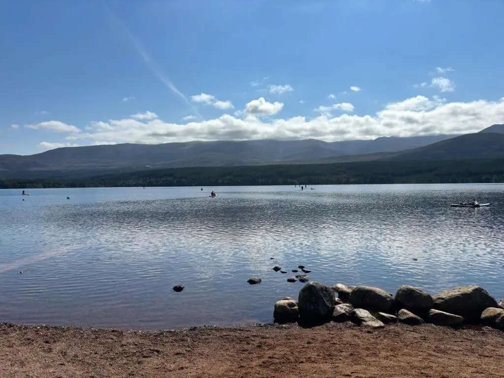 a large body of water with mountains in the background at Shetland Cottage Kincraig in Kincraig