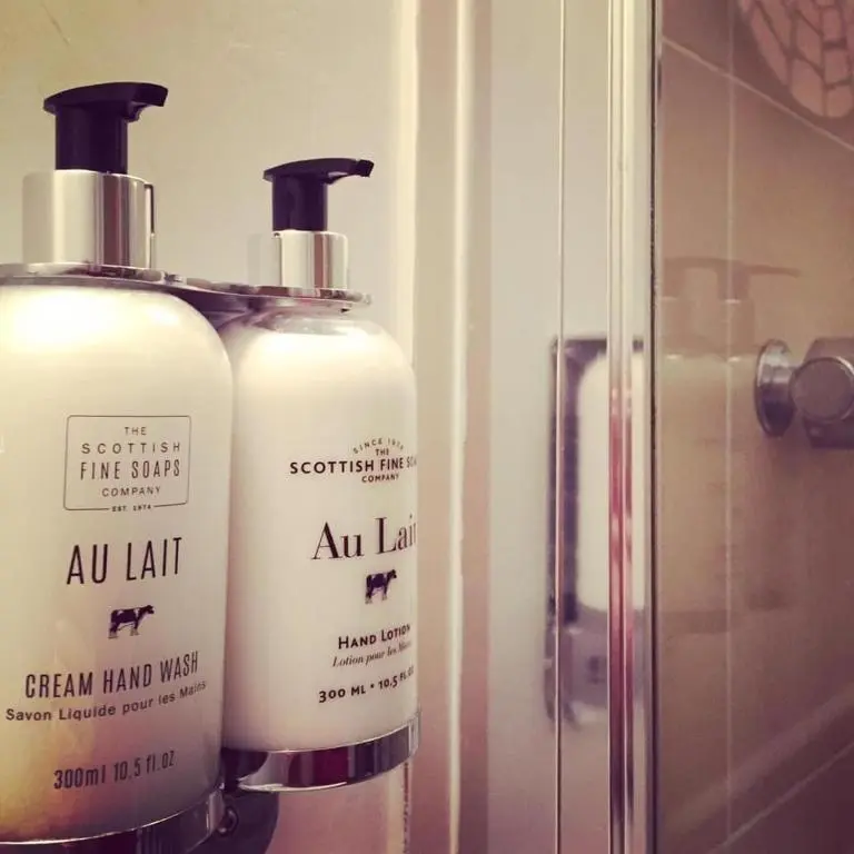 a couple of bottles of soap on a shelf at Island View Guest House in Ullapool