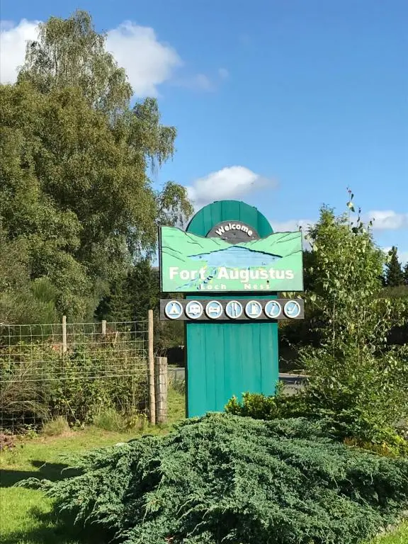 a sign for aix appliances in a field at Carn A Chuilinn House in Fort Augustus