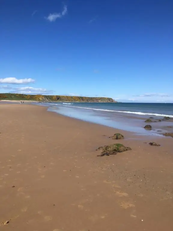 a sandy beach with footprints in the sand at The Royal Oak Hotel in Cullen