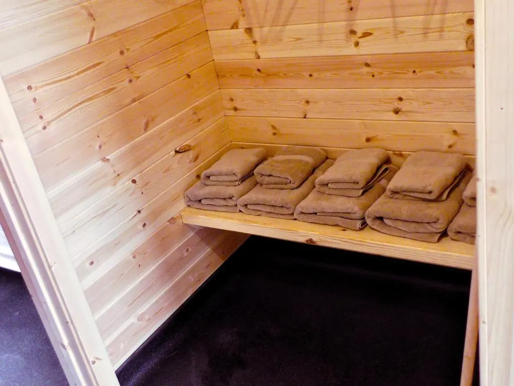 a wooden sauna with some brown towels in it at Tigh an Each B&B & Laggan Glamping in Newtonmore