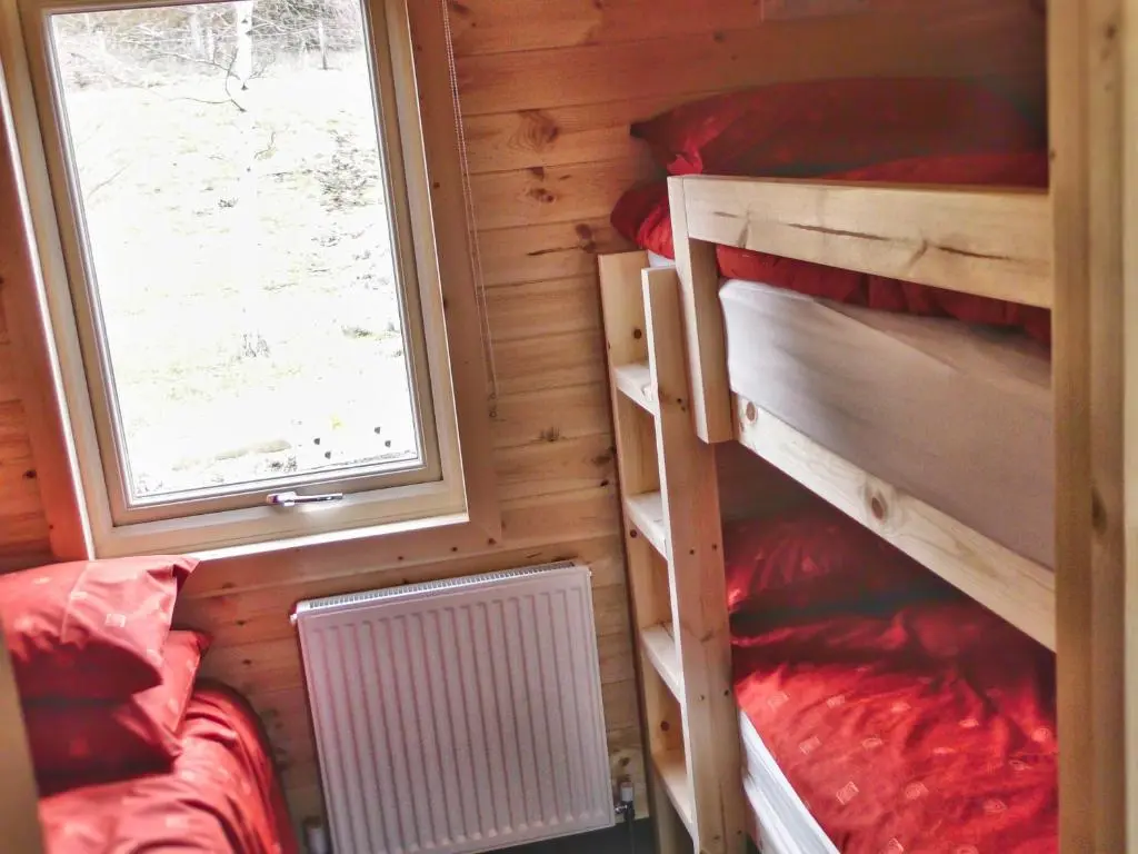 a small room with two bunk beds and a window at Tigh an Each B&B & Laggan Glamping in Newtonmore
