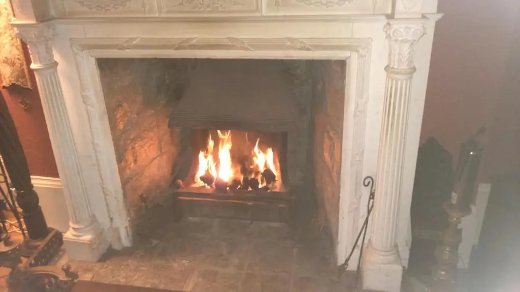 a fireplace with a fire in it at Disblair House in Newmachar