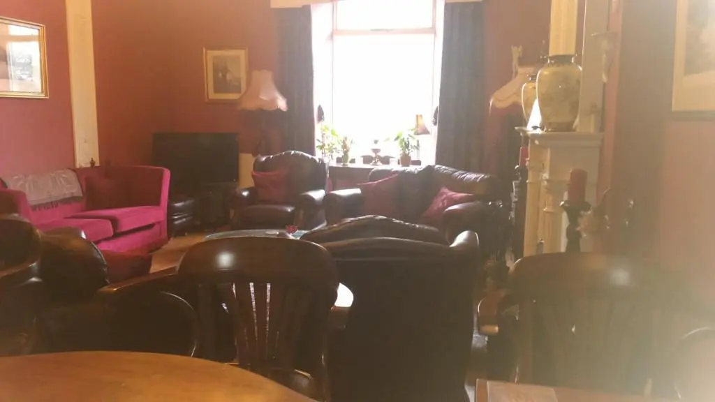 a living room with a couch and chairs and a window at Disblair House in Newmachar