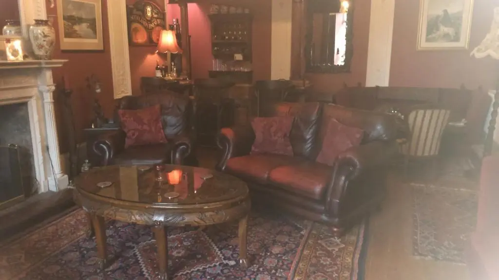 a living room with leather chairs and a coffee table at Disblair House in Newmachar