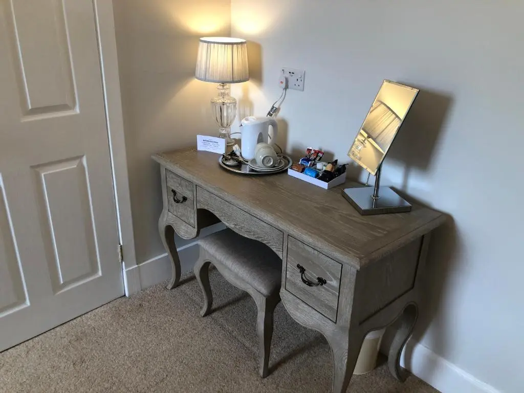 a desk with a lamp on top of it with a lamp at Ballifeary House in Inverness
