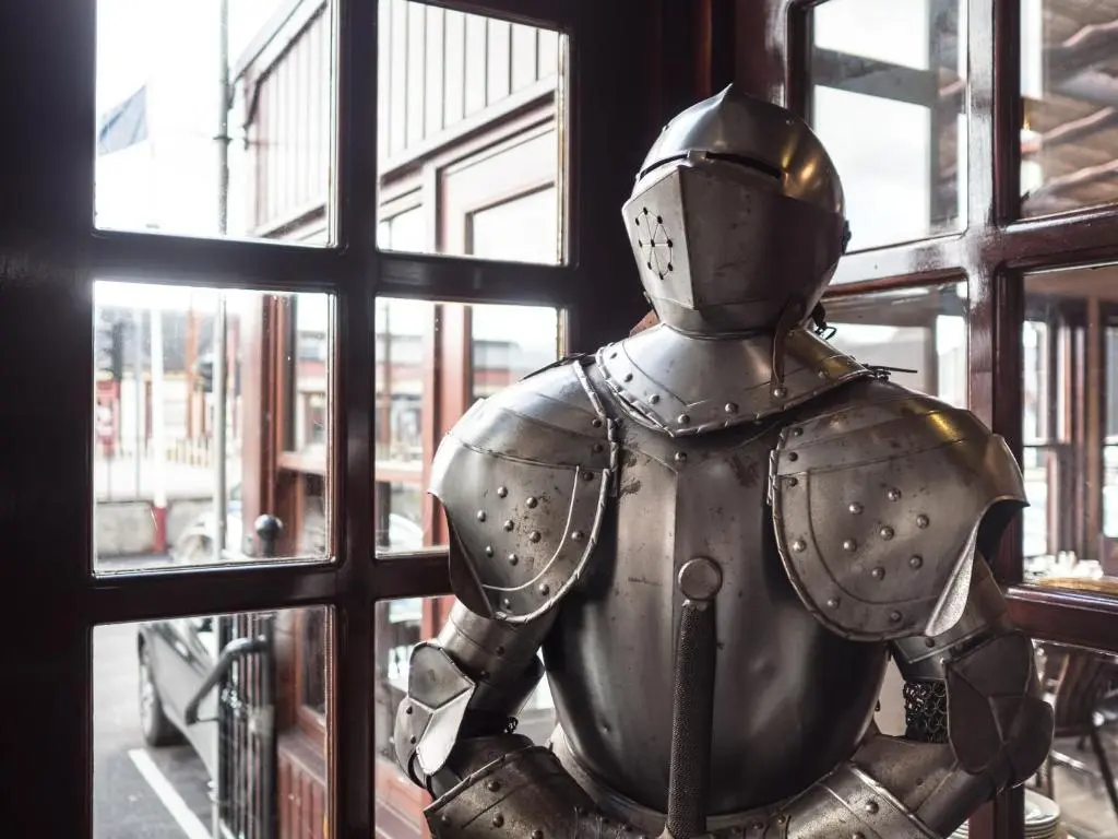 a knight statue sitting in front of a window at Cairngorm Hotel in Aviemore
