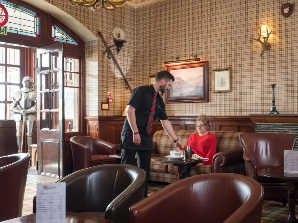 a man standing in a restaurant with a girl in a table at Cairngorm Hotel in Aviemore