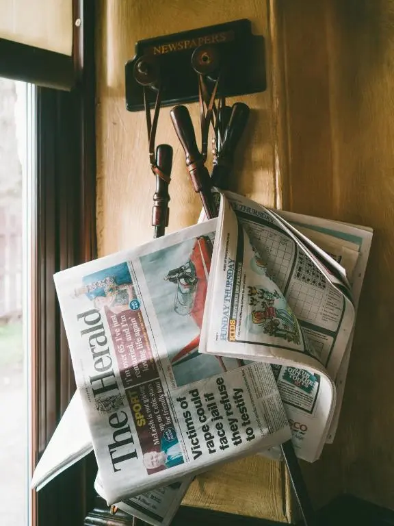 two newspapers are hanging on a wall at Cairngorm Hotel in Aviemore