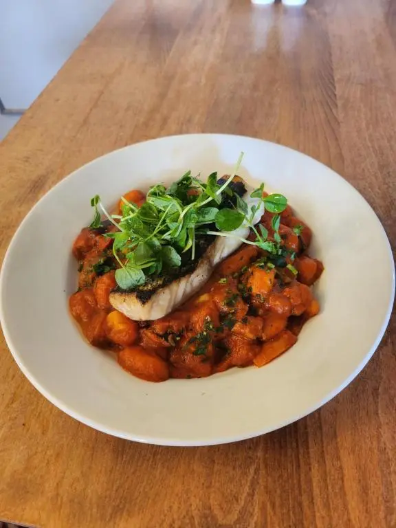 a white plate of food on a wooden table at Garth Hotel in Grantown on Spey