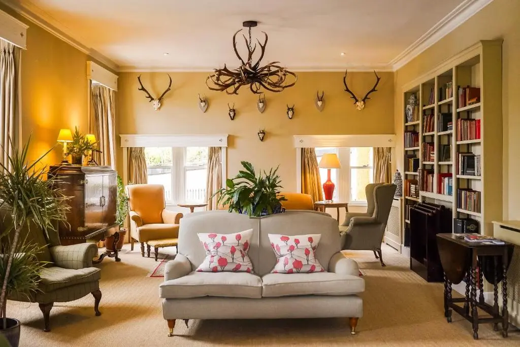 a living room with a couch and chairs at Craigellachie Hotel of Speyside in Craigellachie