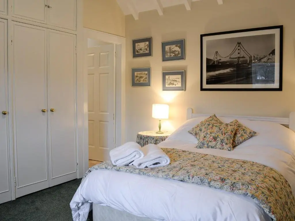a bedroom with a bed with towels on it at Inverchroskie Cottage in Enochdhu