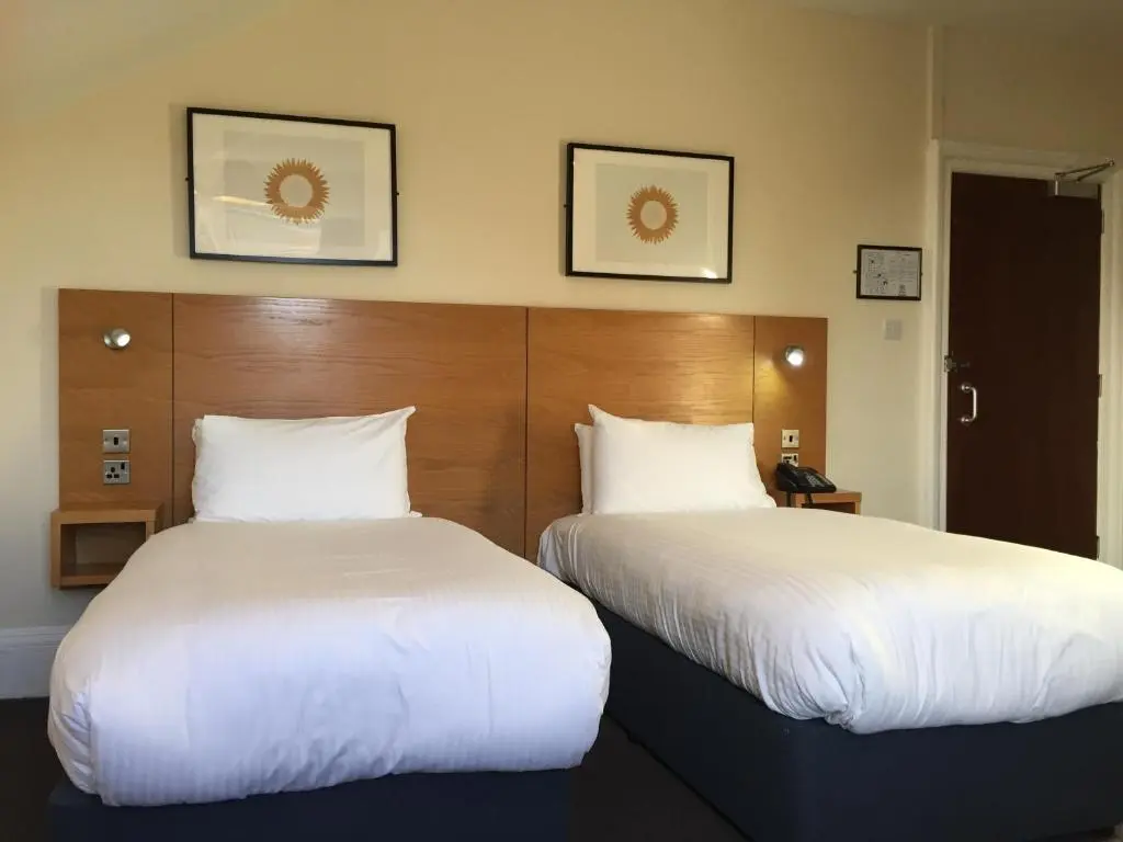 two beds sitting next to each other in a hotel room at Stotfield Hotel in Lossiemouth
