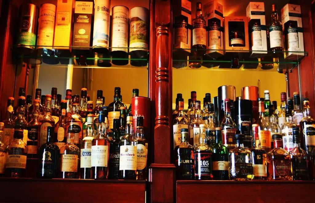 a bar filled with lots of bottles of alcohol at Stotfield Hotel in Lossiemouth