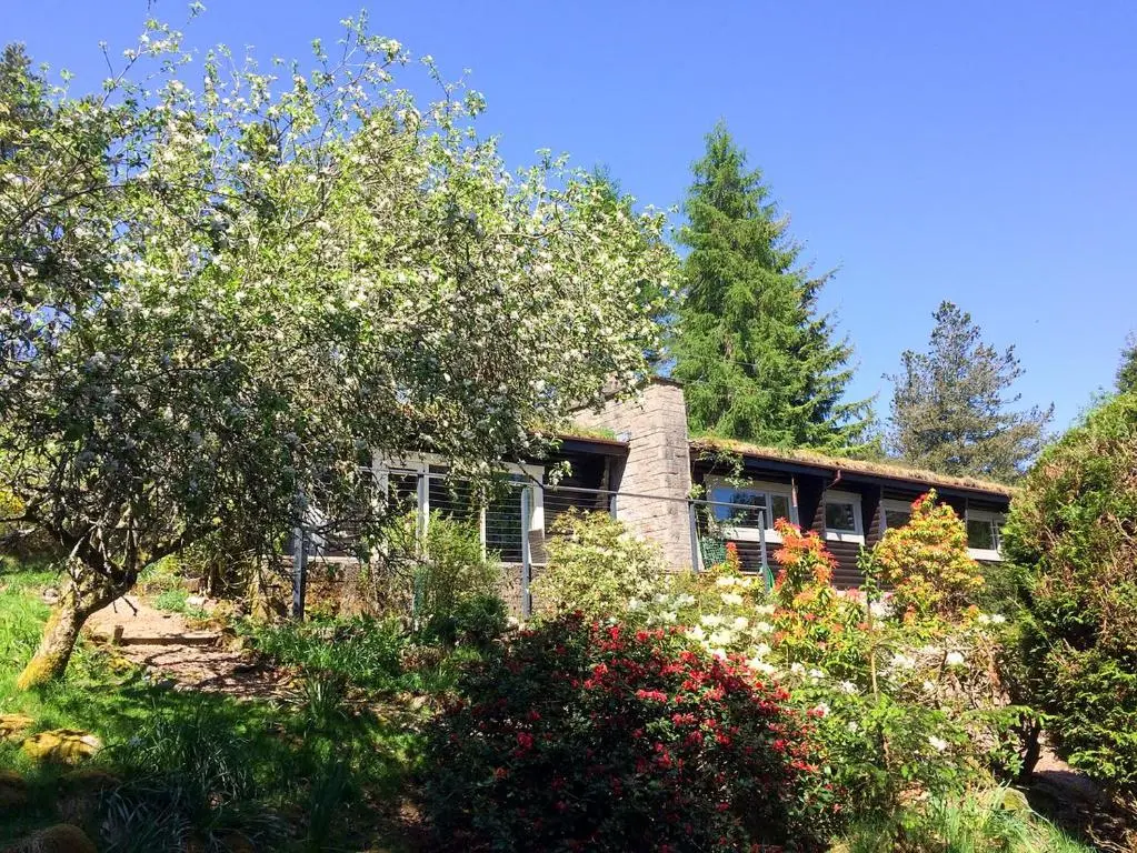 a stone house in the middle of a garden at Glen Hideaway in Balnald