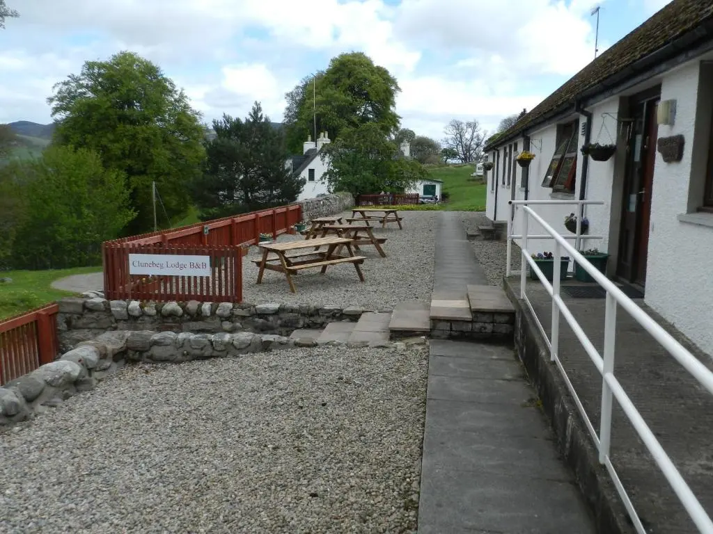 a group of picnic tables outside of a building at Clunebeg Lodge in Drumnadrochit