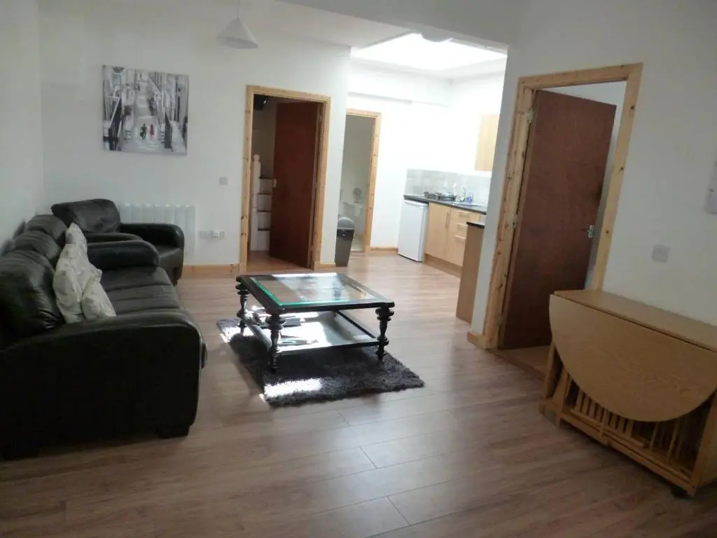 a living room with a couch and a coffee table at Millburn Apartments in Inverness