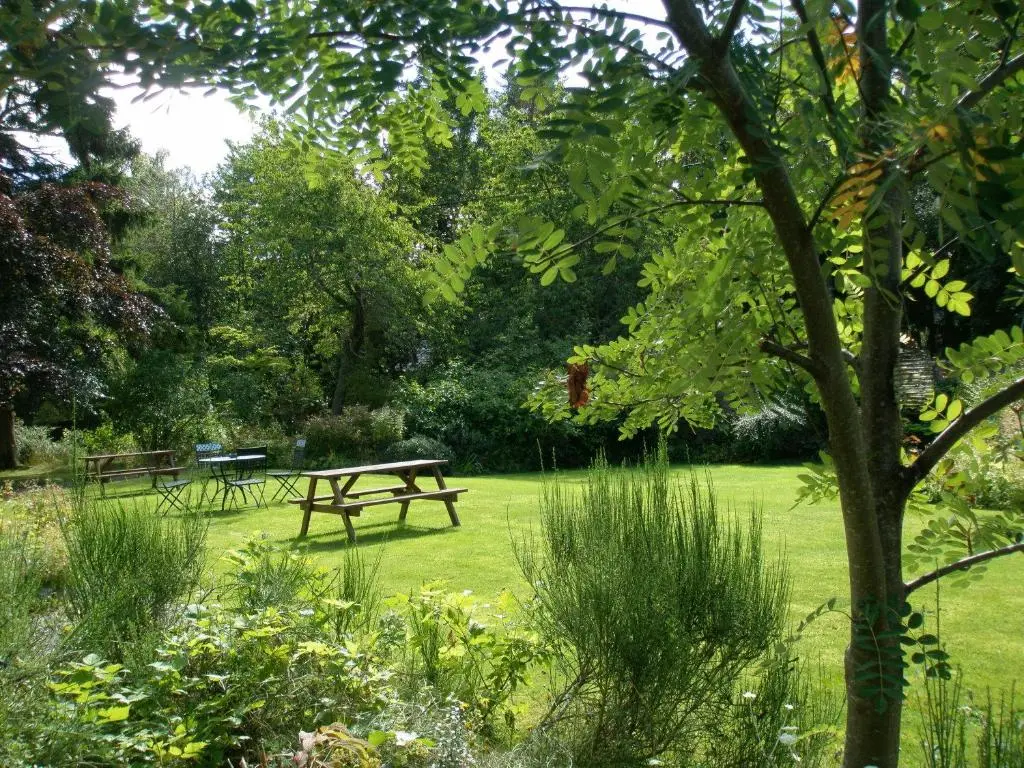 a park with two picnic tables in the grass at No 45, Ballater in Ballater