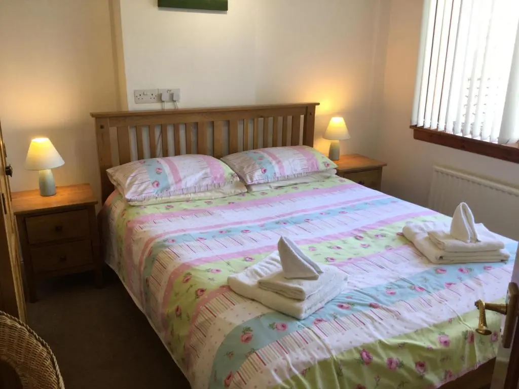 a bedroom with a bed with towels on it at 3 Bedroom Culduthel House Free Parking in Inverness